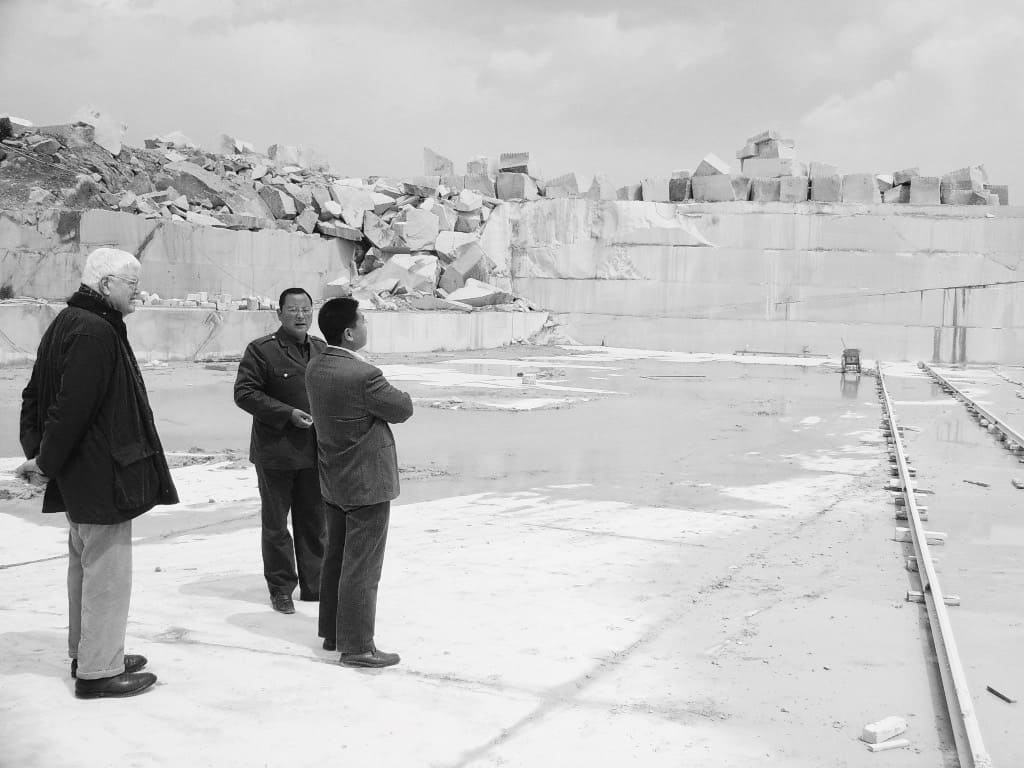 The men standing in a stone quarry.